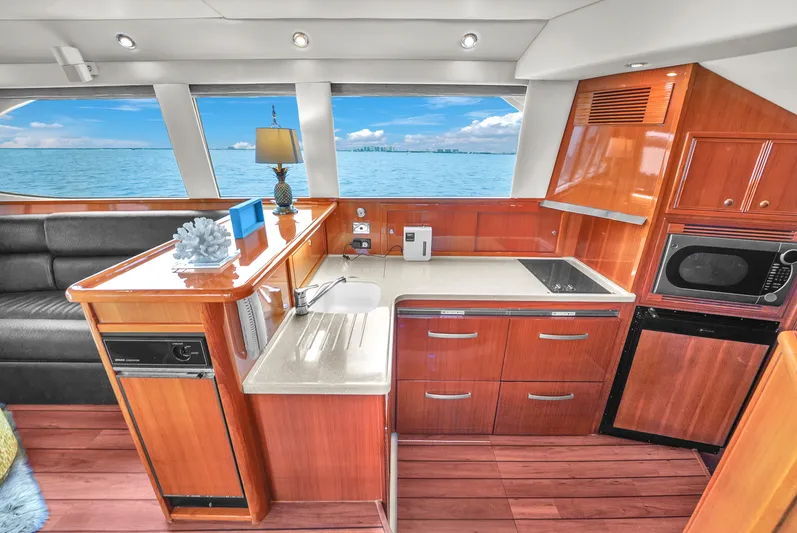  Yacht Photos Pics Luxurious 2008 Riviera 51 Enclosed Bridge yacht interior with modern kitchen and ocean view.