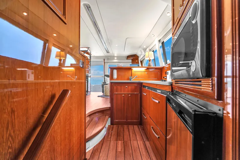  Yacht Photos Pics Luxurious 2008 Riviera 51 Enclosed Bridge yacht interior with wooden cabinetry and modern appliances.