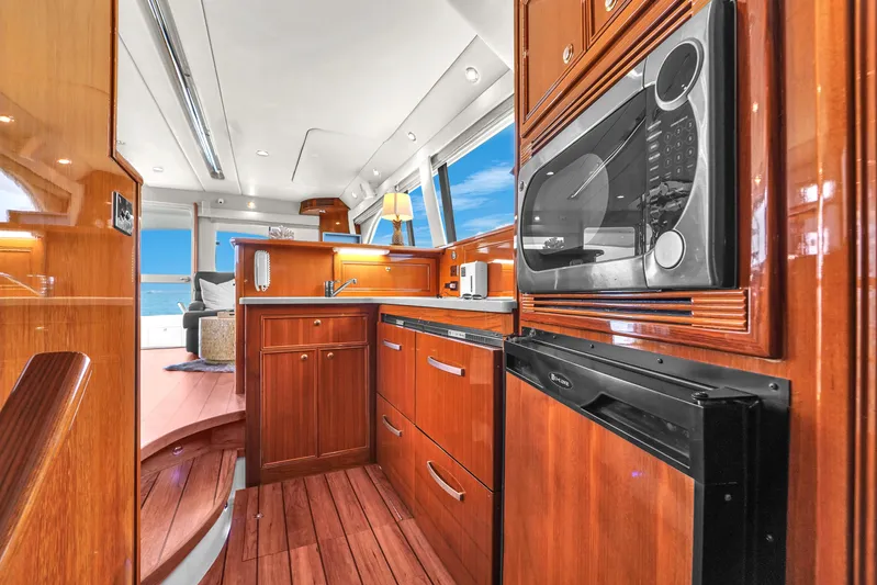  Yacht Photos Pics Luxurious 2008 Riviera 51 Enclosed Bridge yacht kitchen with wood cabinetry and modern appliances.