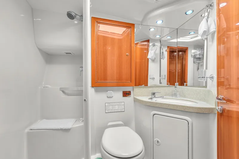  Yacht Photos Pics Luxurious bathroom in 2008 Riviera 51 Enclosed Bridge yacht with modern fixtures and wooden cabinetry.