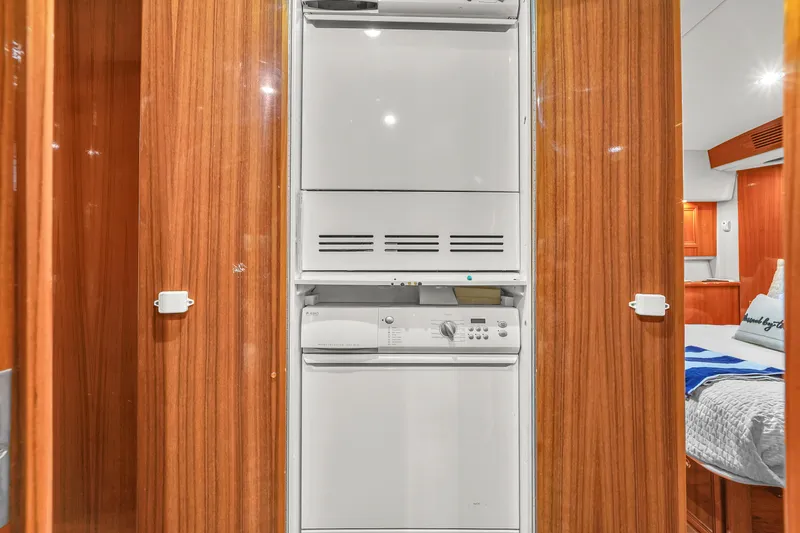  Yacht Photos Pics 2008 Riviera 51 Enclosed Bridge interior with built-in laundry appliances and wooden cabinetry.