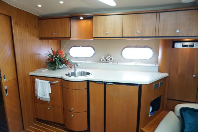 The Pearl Yacht Photos Pics 2007 Tiara Yachts 3900 Sovran interior with wooden cabinetry and modern kitchenette.
