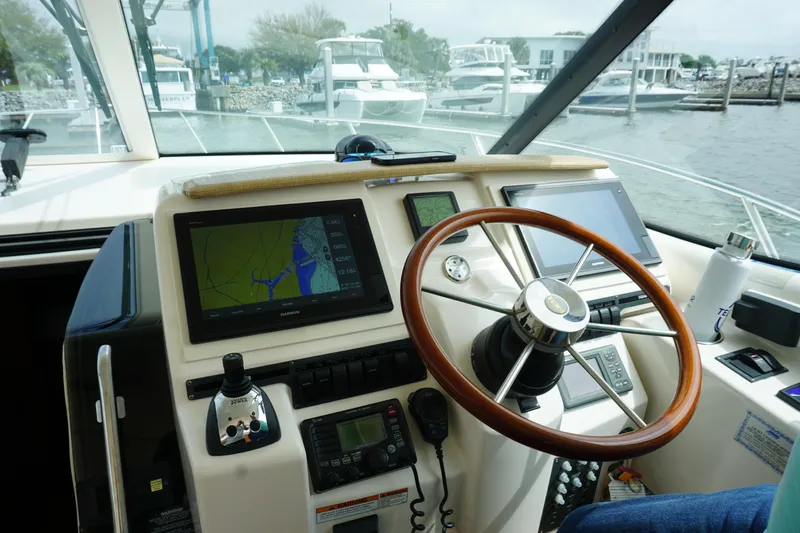 The Pearl Yacht Photos Pics 2007 Tiara Yachts 3900 Sovran helm with navigation screens and wooden steering wheel.