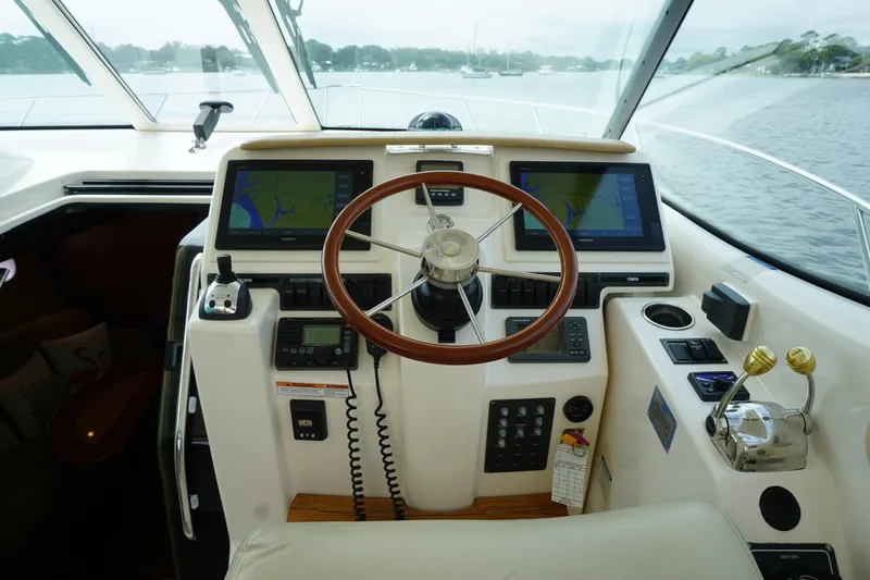 The Pearl Yacht Photos Pics 2007 Tiara Yachts 3900 Sovran helm with dual navigation screens and wooden steering wheel.