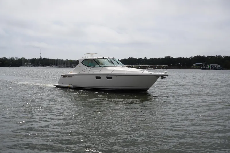 The Pearl Yacht Photos Pics 2007 Tiara Yachts 3900 Sovran cruising on a calm lake under cloudy skies.