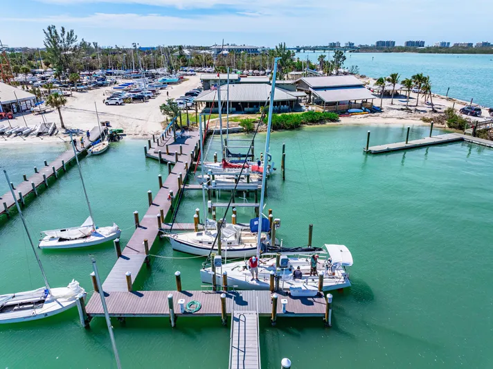 Encore Yacht Photos Pics 2011 J Boats J/95 docked at a scenic marina with clear turquoise water.