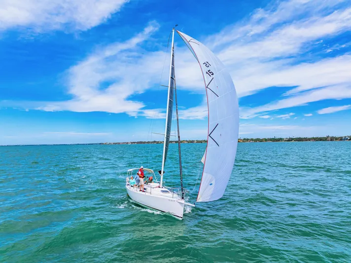 Encore Yacht Photos Pics Sailing J Boats J/95, 2011 model, on clear blue waters under a vibrant sky.