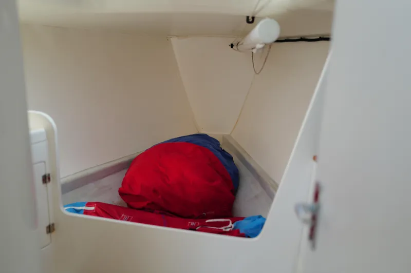 Encore Yacht Photos Pics Interior cabin storage of 2011 J Boats J/95 sailboat with red and blue gear.