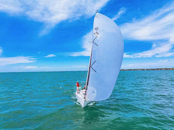 Encore Yacht Photos Pics Sailing J Boats J/95, 2011 model, on clear blue waters under a vibrant sky.