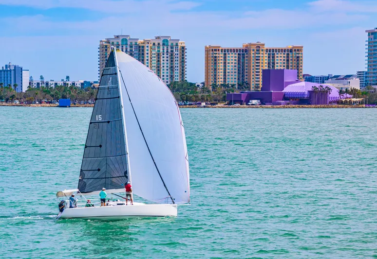 Encore Yacht Photos Pics Sailboat J/95 (2011) cruising near city skyline on calm waters.