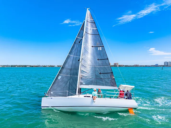 Encore Yacht Photos Pics 2011 J Boats J/95 sailing on clear blue waters under a sunny sky.