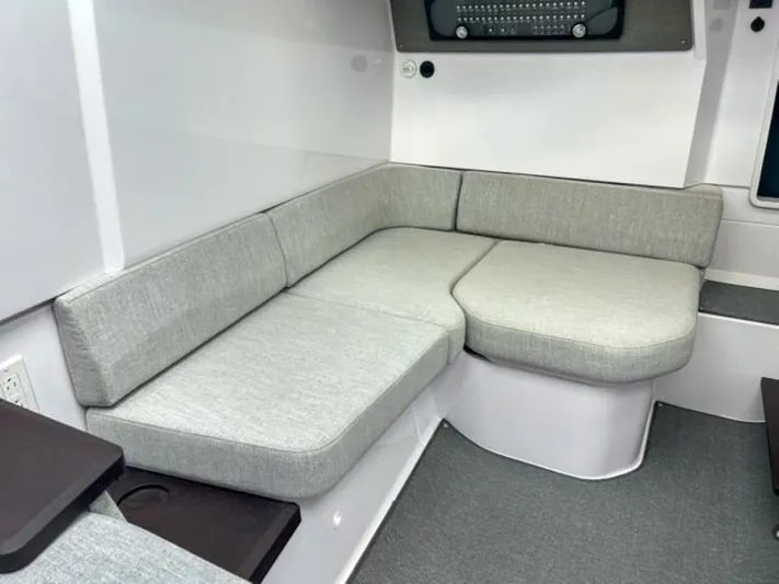  Yacht Photos Pics 2024 Axopar 37 Sun Top interior seating area with grey cushions.