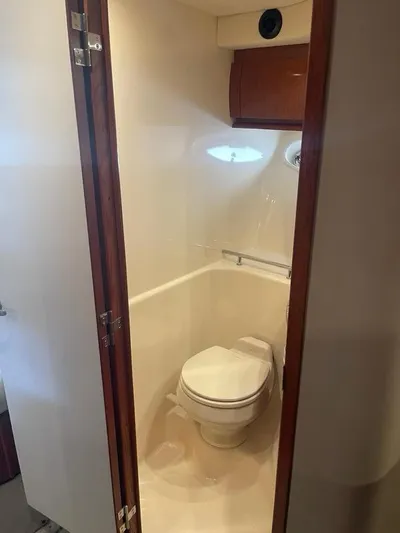 Lucky Duck Yacht Photos Pics 2005 Sea Ray 420 Sundancer bathroom interior with toilet and wooden cabinetry.