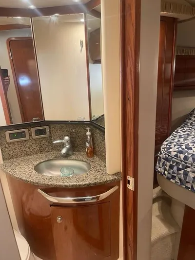 Lucky Duck Yacht Photos Pics 2005 Sea Ray 420 Sundancer bathroom with granite countertop and modern fixtures.