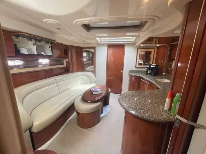 Lucky Duck Yacht Photos Pics Luxurious interior of 2005 Sea Ray 420 Sundancer yacht with elegant seating and modern amenities.