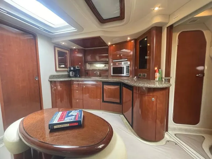 Lucky Duck Yacht Photos Pics Luxurious 2005 Sea Ray 420 Sundancer yacht interior with modern kitchen and dining area.