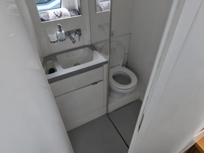 Chin Don Yacht Photos Pics Compact bathroom in 2023 Limitless Seas 45 XLV yacht with sink and toilet.