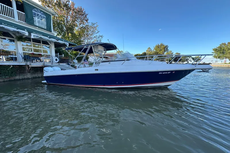  Yacht Photos Pics 1999 Intrepid 339 boat docked by a waterfront restaurant.