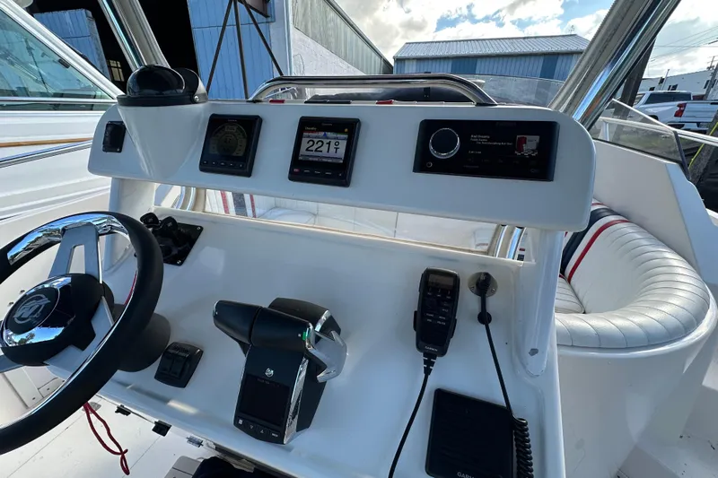  Yacht Photos Pics 1999 Intrepid 339 boat dashboard with steering wheel, controls, and navigation instruments.