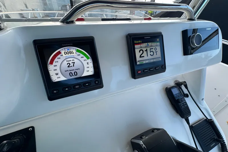  Yacht Photos Pics Control panel of a 1999 Intrepid 339 boat with Garmin displays and radio equipment.