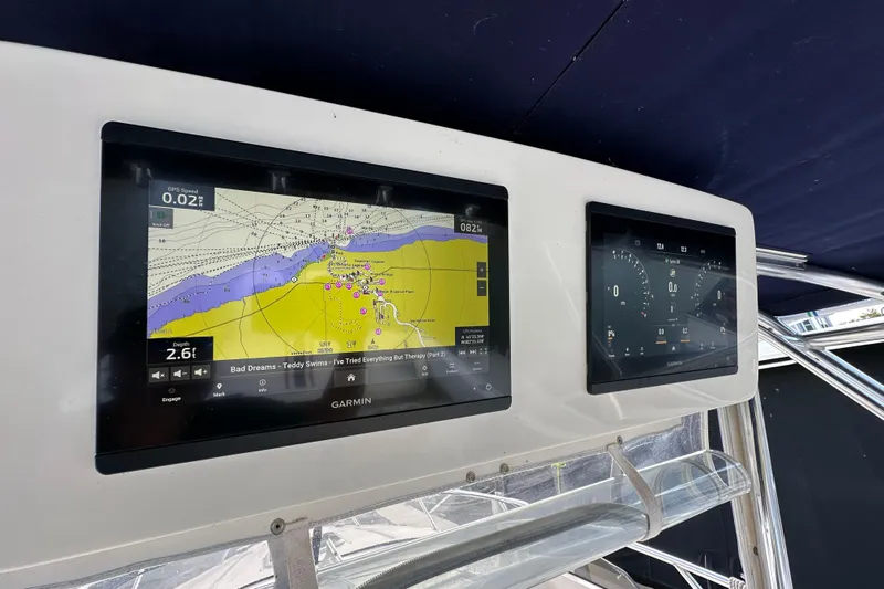  Yacht Photos Pics Garmin navigation screens on a 1999 Intrepid 339 boat dashboard.