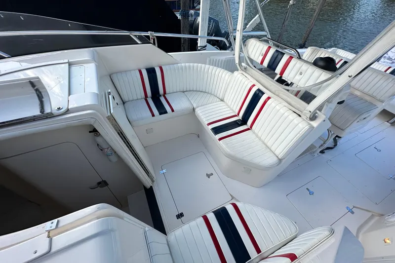  Yacht Photos Pics 1999 Intrepid 339 boat interior with white seating and red, blue stripes.