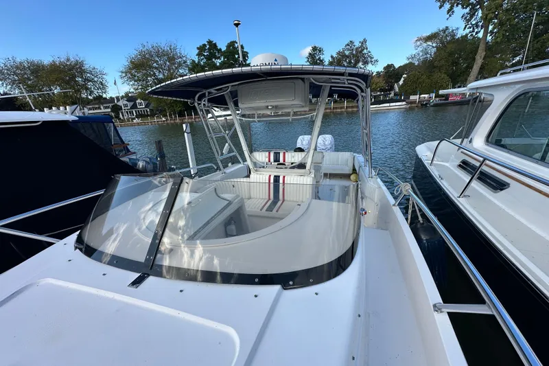  Yacht Photos Pics 1999 Intrepid 339 boat docked, featuring sleek design and spacious seating area.