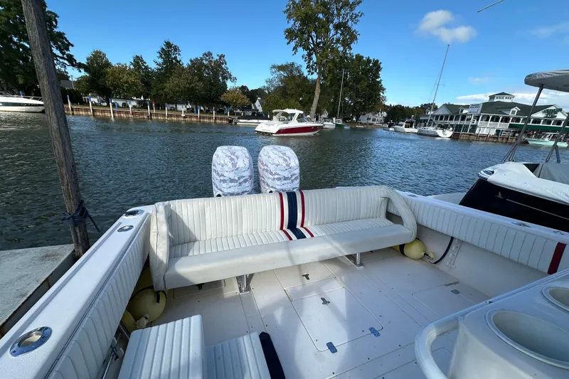  Yacht Photos Pics 1999 Intrepid 339 boat with seating, docked by a scenic waterfront.
