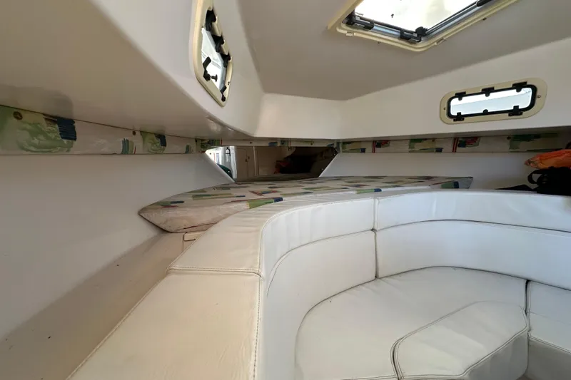  Yacht Photos Pics Interior cabin of a 1999 Intrepid 339 boat with white seating and windows.