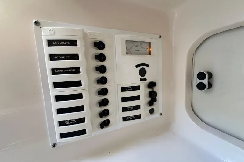  Yacht Photos Pics Control panel of a 1999 Intrepid 339 boat with labeled switches and voltmeter.