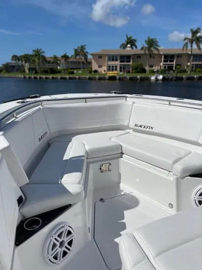  Yacht Photos Pics 2019 Blackfin 272 CC boat with white seating, docked near waterfront homes.