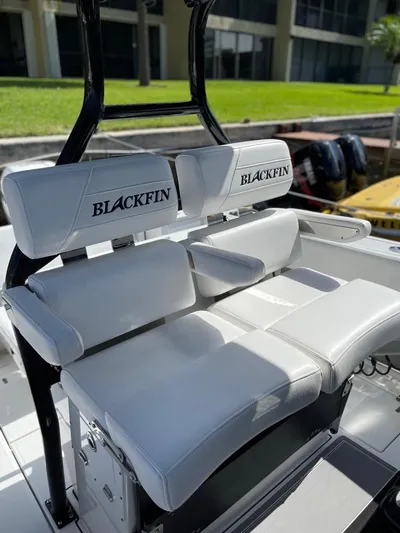  Yacht Photos Pics 2019 Blackfin 272 CC boat with white cushioned seating and branded backrests.