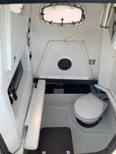  Yacht Photos Pics 2019 Blackfin 272 CC cabin interior with seating and marine toilet.