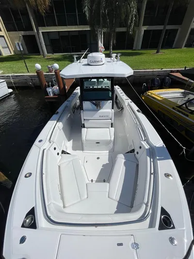  Yacht Photos Pics 2019 Blackfin 272 CC boat docked, featuring spacious seating and modern design.