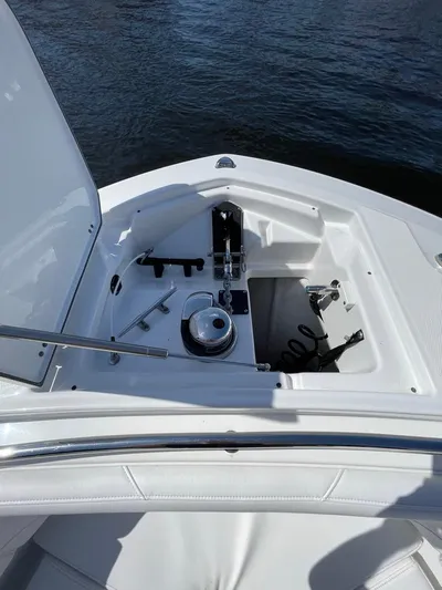  Yacht Photos Pics 2019 Blackfin 272 CC boat anchor compartment with open hatch, docked on water.