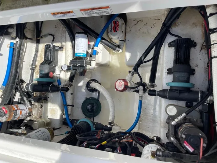  Yacht Photos Pics 2019 Blackfin 272 CC boat engine compartment with various pumps and hoses.