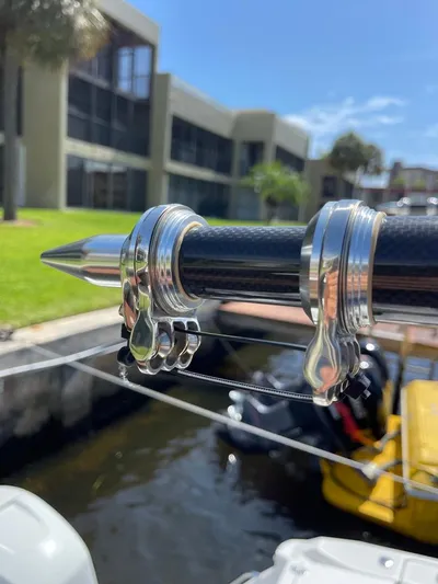  Yacht Photos Pics Close-up of a 2019 Blackfin 272 CC boat's fishing rod holder, docked near modern buildings.