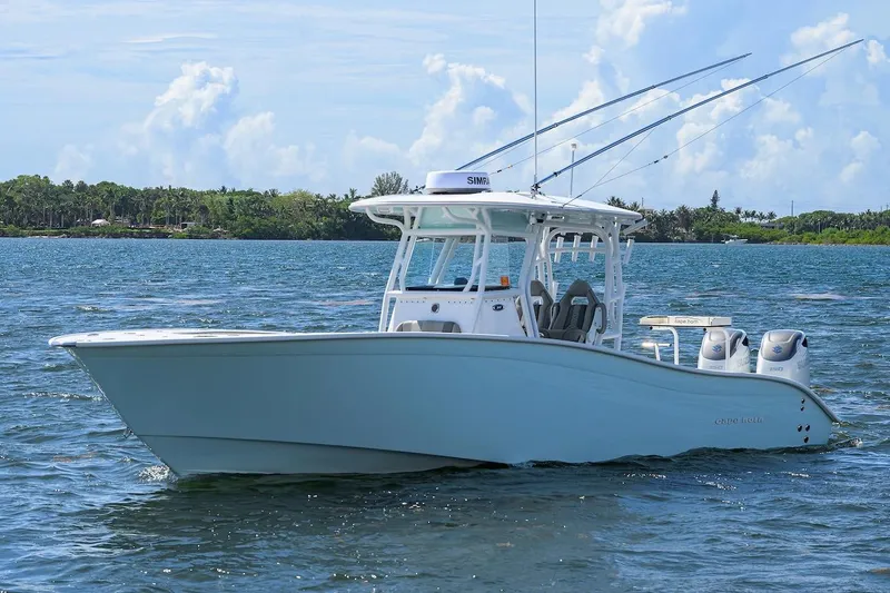  Yacht Photos Pics 2024 Cape Horn 31 T boat on water, clear sky, lush shoreline in background.