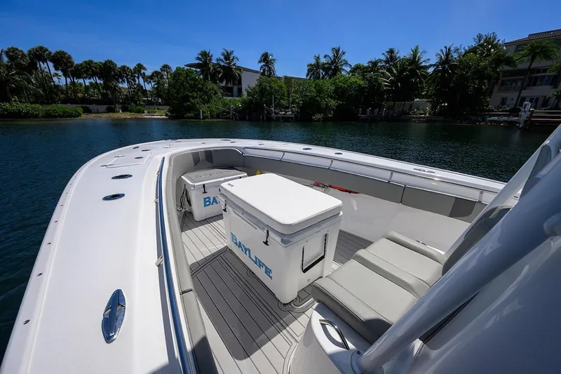  Yacht Photos Pics 2024 Cape Horn 31 T boat interior with seating and coolers, docked by lush greenery.
