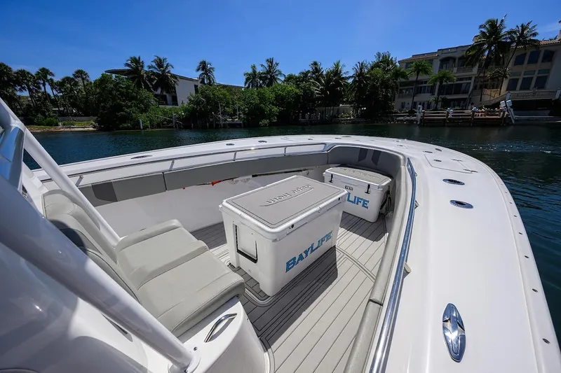  Yacht Photos Pics 2024 Cape Horn 31 T boat interior with seating and coolers, docked by waterfront homes.
