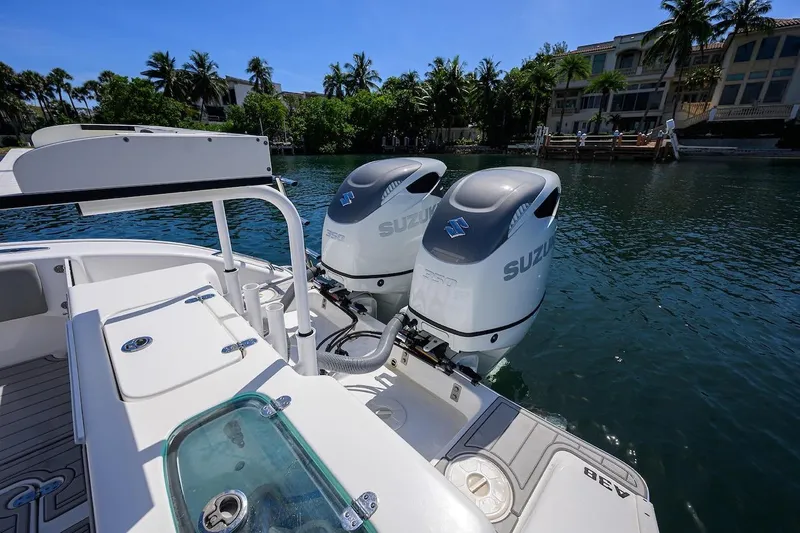  Yacht Photos Pics 2024 Cape Horn 31 T boat with dual Suzuki outboard motors on a sunny waterfront.