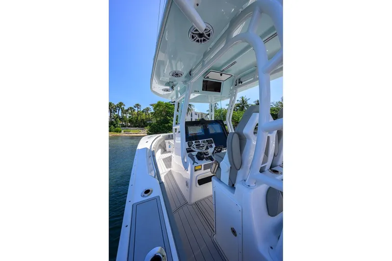  Yacht Photos Pics 2024 Cape Horn 31 T boat interior with modern helm and seating, docked by lush greenery.
