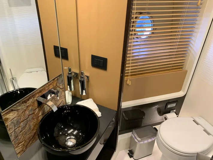 Fantastic Yacht Photos Pics Modern bathroom on a 2019 Azimut 77S yacht with sleek fixtures and porthole window.
