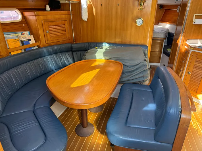 J Renee Yacht Photos Pics Interior of 2004 Catalina 42 MkII sailboat with blue seating and wooden table.