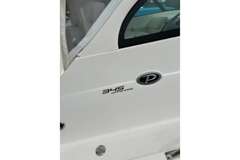 Jambo Yacht Photos Pics 2011 Pursuit OS 345 Offshore boat, side view with logo and window.