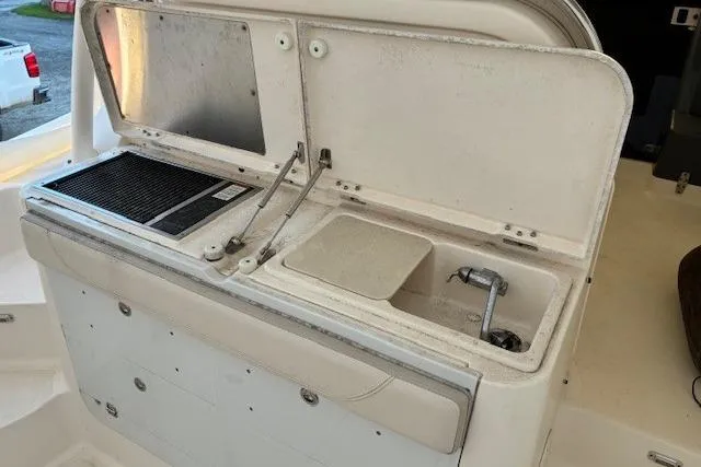 Jambo Yacht Photos Pics 2011 Pursuit OS 345 Offshore boat interior with sink and grill station.