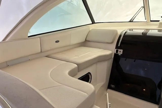 Jambo Yacht Photos Pics Interior seating of 2011 Pursuit OS 345 Offshore boat, featuring beige upholstery and sleek design.