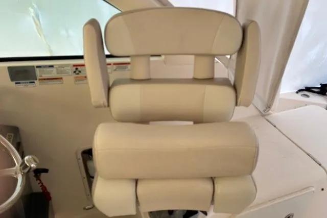 Jambo Yacht Photos Pics Captain's chair on 2011 Pursuit OS 345 Offshore boat, featuring beige upholstery.