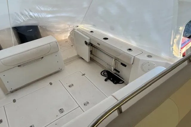 Jambo Yacht Photos Pics 2011 Pursuit OS 345 Offshore boat interior with white seating and storage compartments.