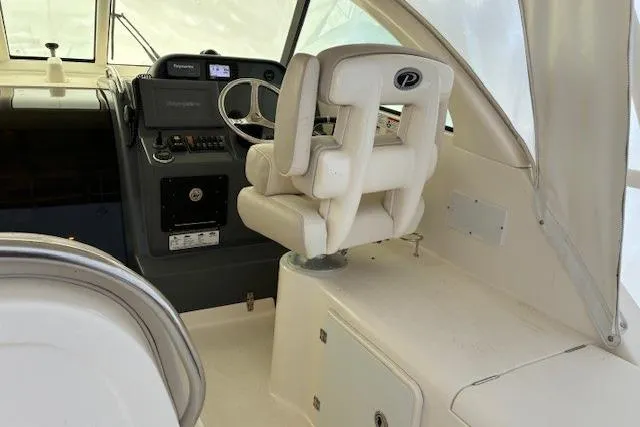 Jambo Yacht Photos Pics 2011 Pursuit OS 345 Offshore boat interior with helm and captain's chair.